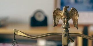 a golden scale with an eagle on top of it