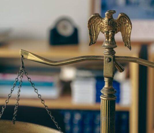 a golden scale with an eagle on top of it