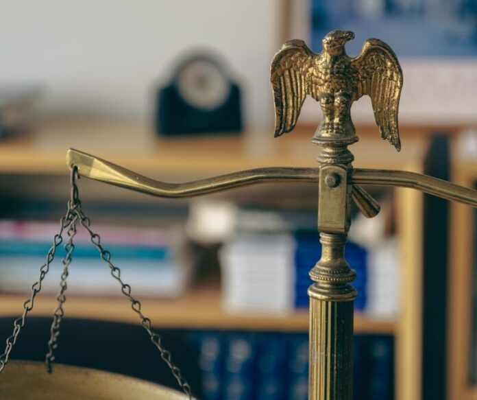 a golden scale with an eagle on top of it