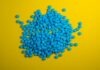 a pile of blue pills on a yellow background