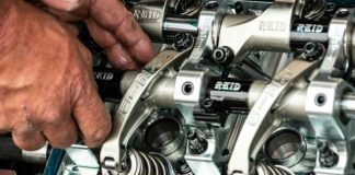 a close up of a person working on a machine