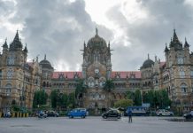 cars parked in front of brown concrete building during daytime