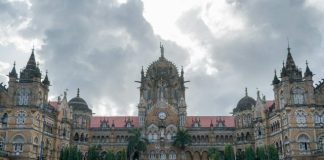 cars parked in front of brown concrete building during daytime