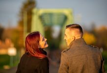 man and woman standing side by side during daytime