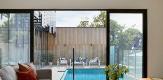 brown sofa near glass window