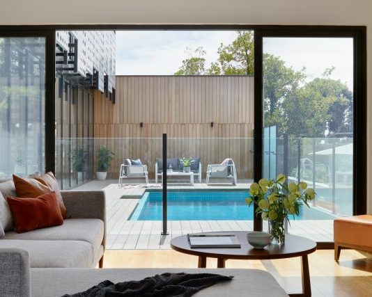 brown sofa near glass window