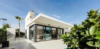 white and grey concrete building near swimming pool under clear sky during daytime