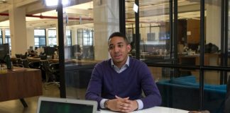 a man sitting at a table with a laptop