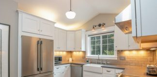 white wooden kitchen cabinet and white pendant lamp