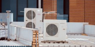 white and gray box fan on brown wooden table