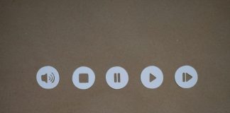 a set of four white buttons on a brown surface