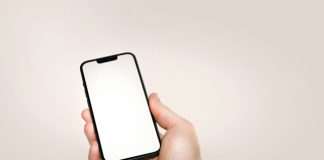 a person holding a cell phone in their hand