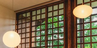 a couple of lights hanging from the side of a window