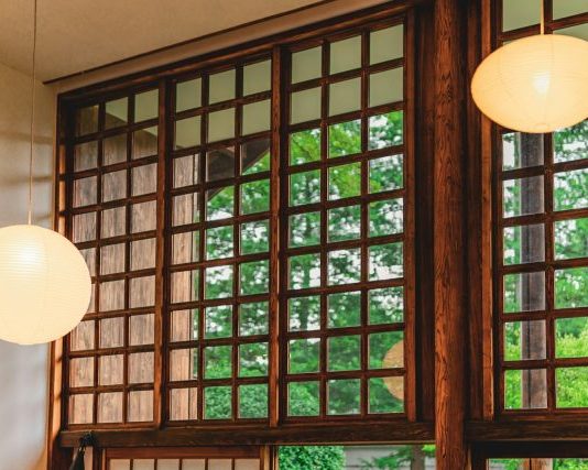 a couple of lights hanging from the side of a window