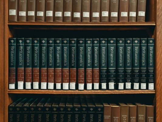 books on brown wooden shelf