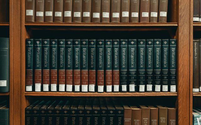 Photo by Clay Banks books on brown wooden shelf