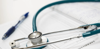 A stethoscope on top of a medical form AI-generated content may be incorrect.