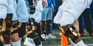 people in white and black jersey shirt and black shorts