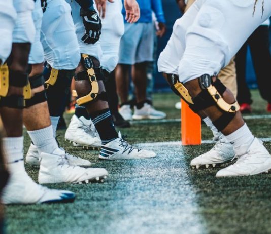 people in white and black jersey shirt and black shorts