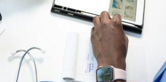 a hand holding a smart watch