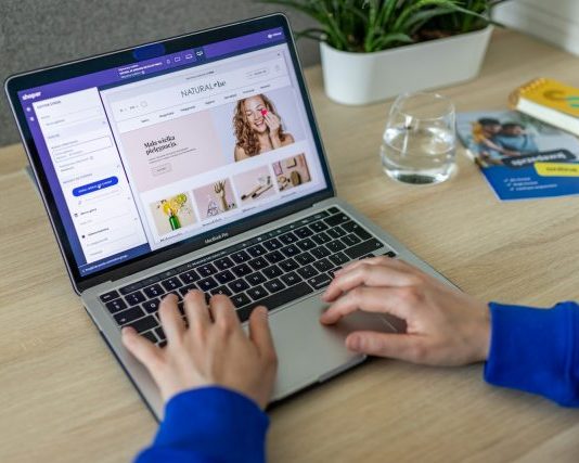 a person typing on a laptop on a table