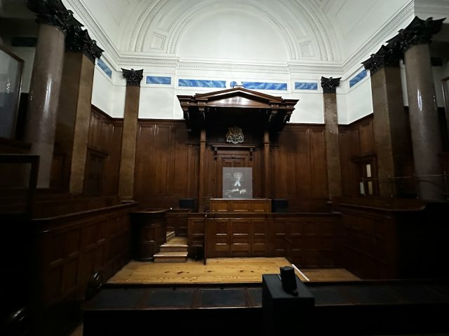 Photo by Dragon White Munthe an empty courtroom with wooden paneling and columns