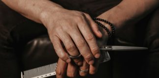 a person holding a knife and a comb