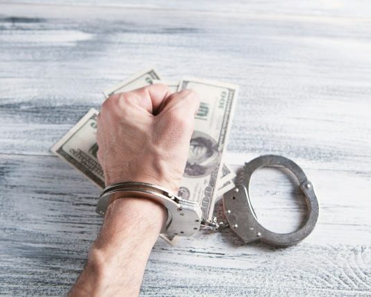 person holding silver ring on 100 us dollar bill