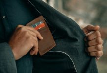 a man holding a wallet in his pocket
