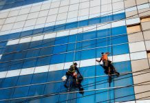 Window washers are cleaning a tall building.