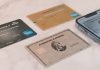 a group of credit cards sitting next to a cell phone