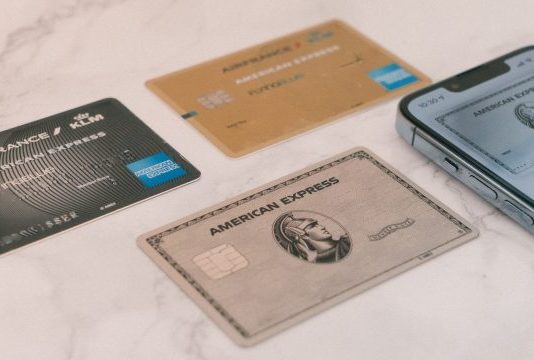 a group of credit cards sitting next to a cell phone