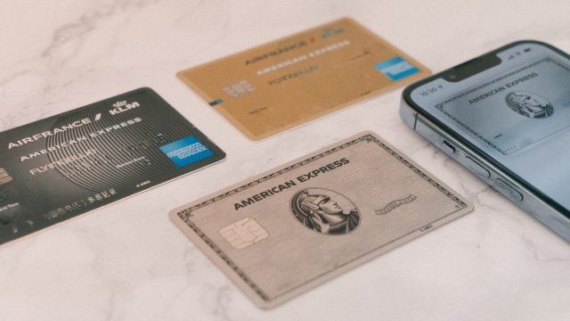 Photo by CardMapr.nl a group of credit cards sitting next to a cell phone