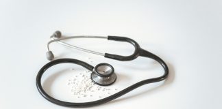 black and silver stethoscope on white surface