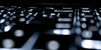 Close-up of a backlit keyboard in the dark.