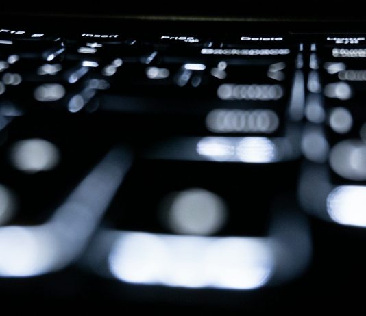 Close-up of a backlit keyboard in the dark.