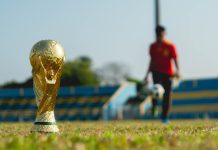 The World Cup Group Stage Was Bigger, Messier And Provided selective focus photography of gold-colored trophy on grass field during daytime
