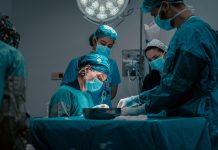 a group of doctors performing surgery on a patient